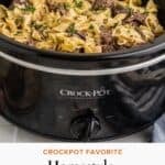Black crockpot shown with seasoned beef cubes cooked fork tender with rich egg noodles.